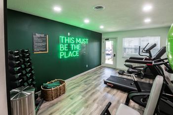 Gym with a variety of equipment including weights